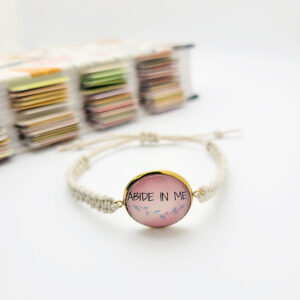 Handmade Abide in Me hemp bracelet with pink glass cabochon charm on natural hemp cord, Christian faith jewelry.