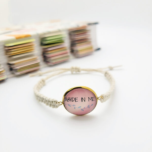 Handmade Abide in Me hemp bracelet with pink glass cabochon charm on natural hemp cord, Christian faith jewelry.