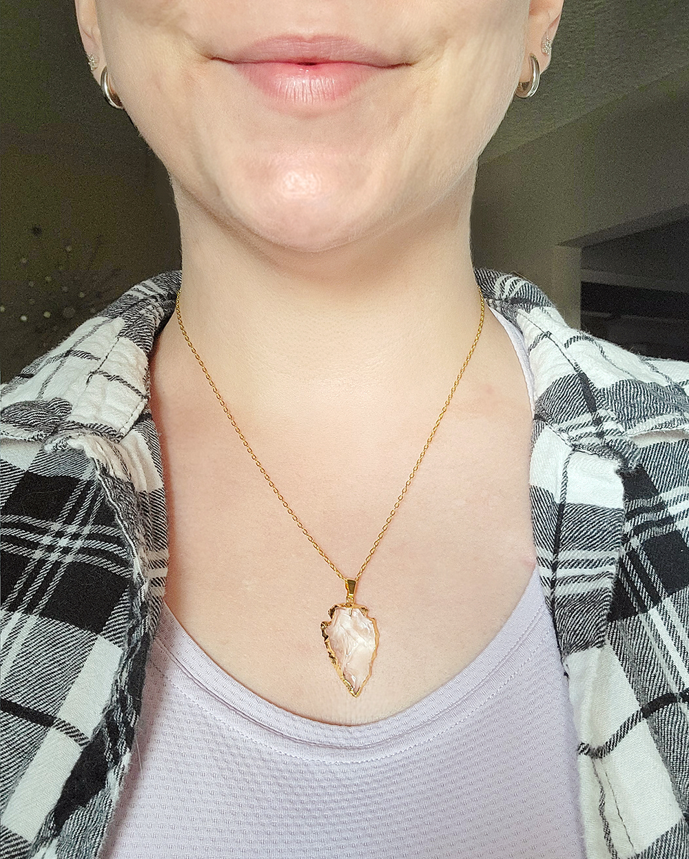 Gold arrowhead quartz pendant necklace worn on a delicate gold chain showing necklace length and scale