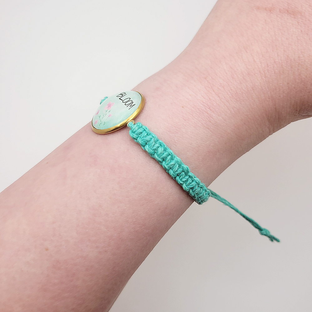 Side view of Bloom hemp bracelet on wrist showing adjustable knot closure and braided turquoise cord detail