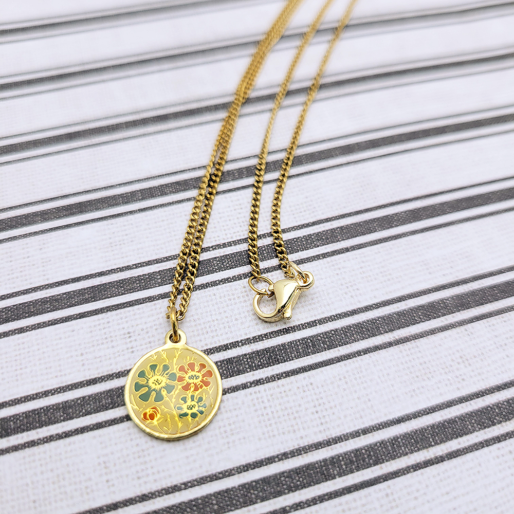 vintage gold cloisonne coin necklace floral pendant green orange enamel flat lay