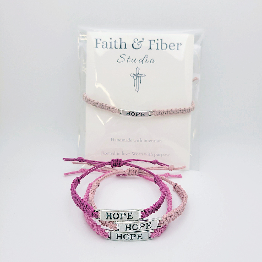 Handmade pink “Hope” bracelet set by Faith & Fiber Studio for breast cancer support, featuring braided cord and silver HOPE charm