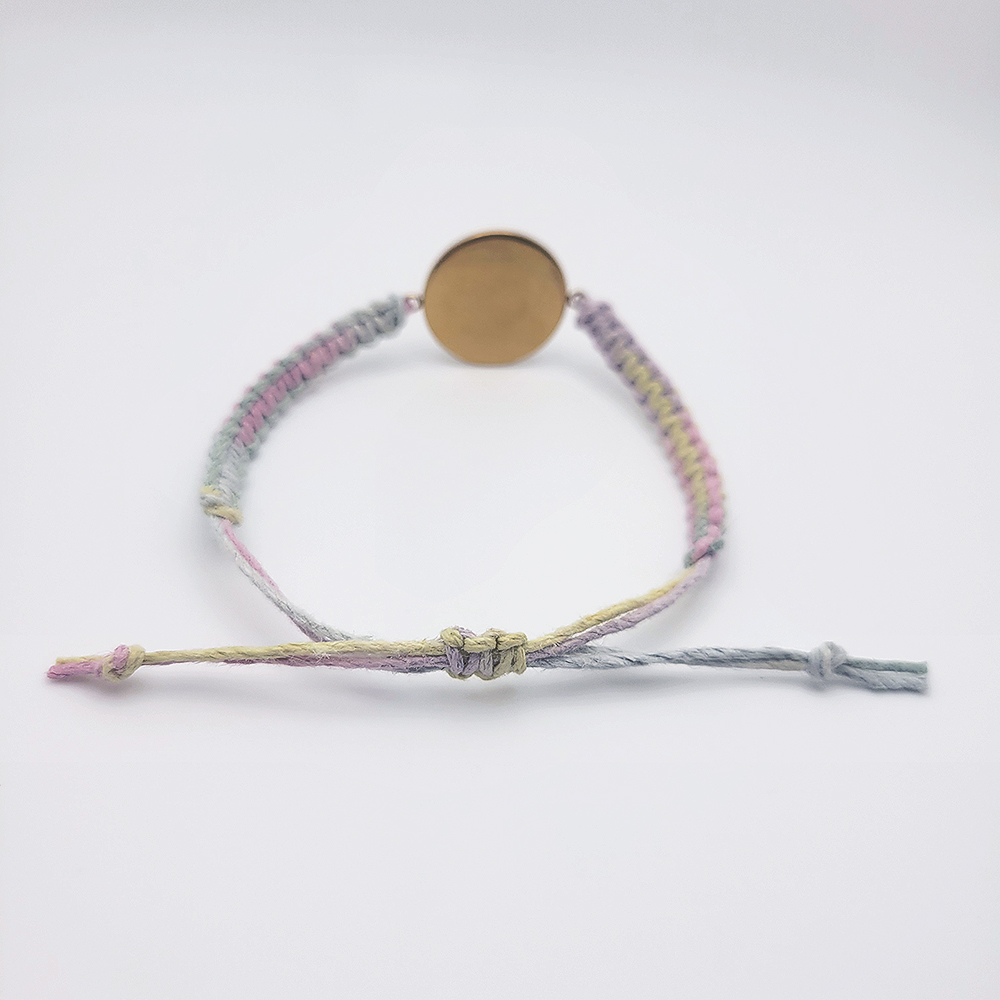 Back view of He Is Risen hemp bracelet showing adjustable sliding knot closure and pastel multicolor cord
