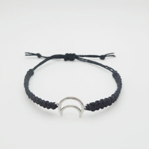 Handmade moon charm hemp bracelet with adjustable black cord and silver crescent charm on white background