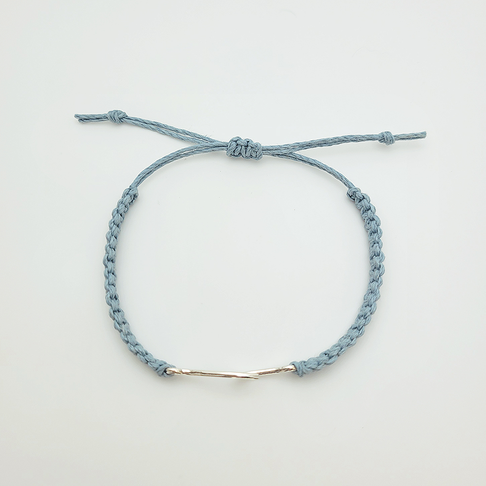 Minimalist wave bracelet on blue hemp cord with silver wave connector, adjustable handmade jewelry on white background