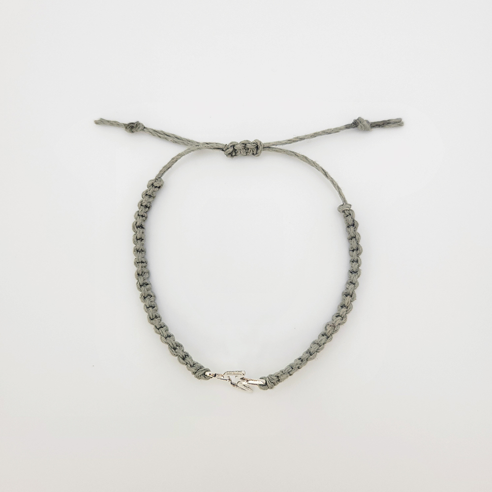 Handmade sage green hemp bracelet with silver dove charm, adjustable Christian faith jewelry on white background