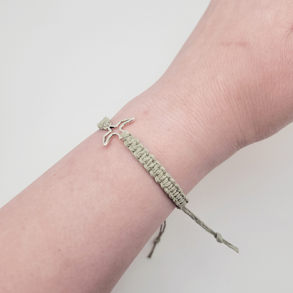 Minimalist hemp cord bracelet in stone green with silver dove charm, adjustable Christian bracelet close-up