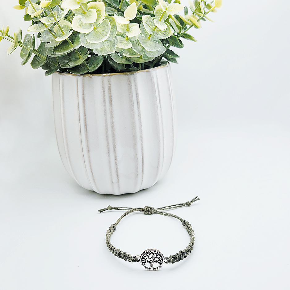 tree of life hemp bracelet styled with plant on white surface minimalist faith jewelry