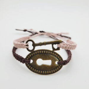 Matching lock and key hemp bracelet set with antique bronze charms, handmade with adjustable soft pink and brown cords.
